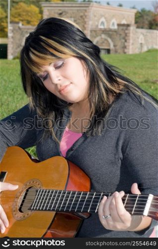 Woman playing the guitar