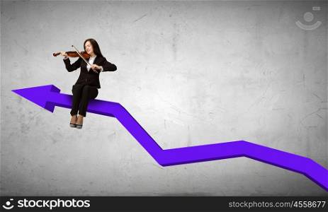 Woman playing violin. Young businesswoman sitting on increasing graph and playing violin