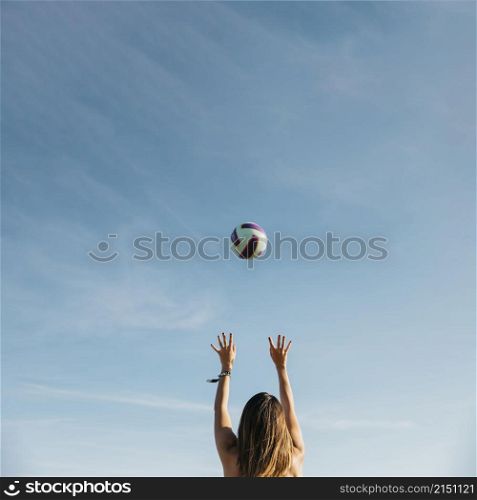 woman playing volleyball beach