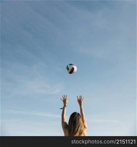 woman playing volleyball beach