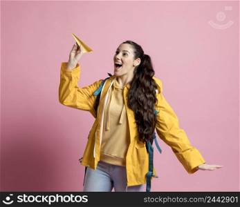 woman playing with paper made plane