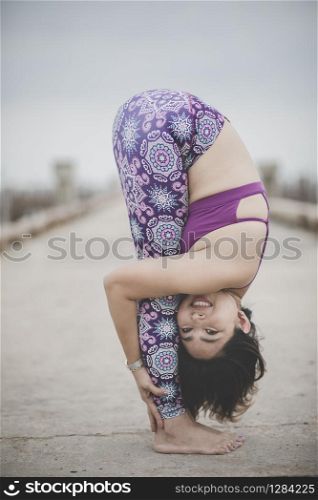 woman playing yoga pose on location