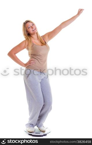 Woman plus size large happy girl with weight scale celebrating weightloss progress after diet victory, she lost some weight. Healthy lifestyles concept