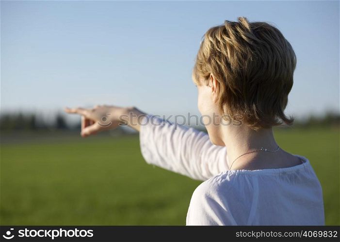 Woman pointing across field