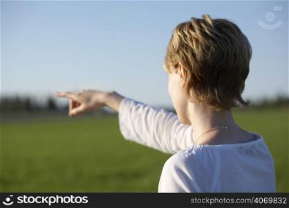 Woman pointing across field