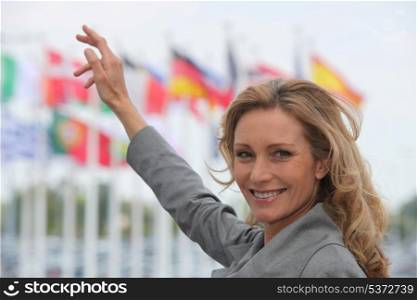 Woman pointing at flags