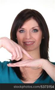 Woman pointing at own hand