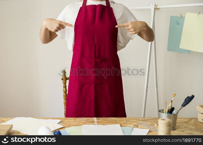 woman pointing her red apron. Resolution and high quality beautiful photo. woman pointing her red apron. High quality and resolution beautiful photo concept