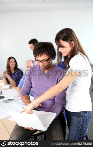 Woman pointing something out to her colleague