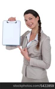 Woman pointing to blank clip-board