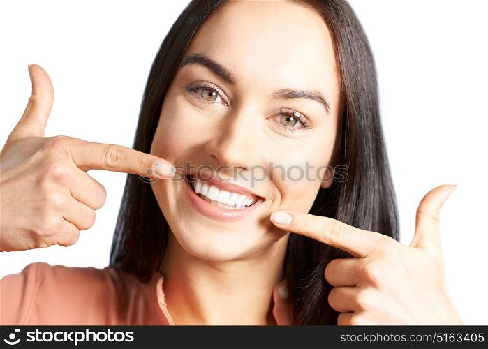 Woman Pointing To Her Smile With Perfect White Teeth