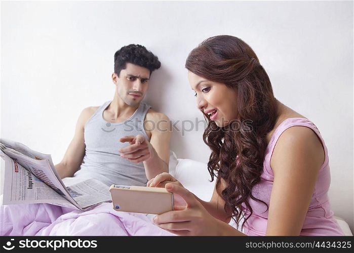 Woman pointing to sms on mobile phone