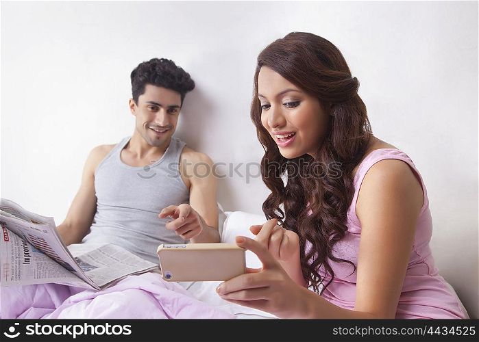 Woman pointing to sms on mobile phone