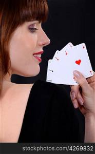 Woman poker player with four aces in hand