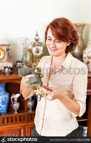 Woman polishing antiques