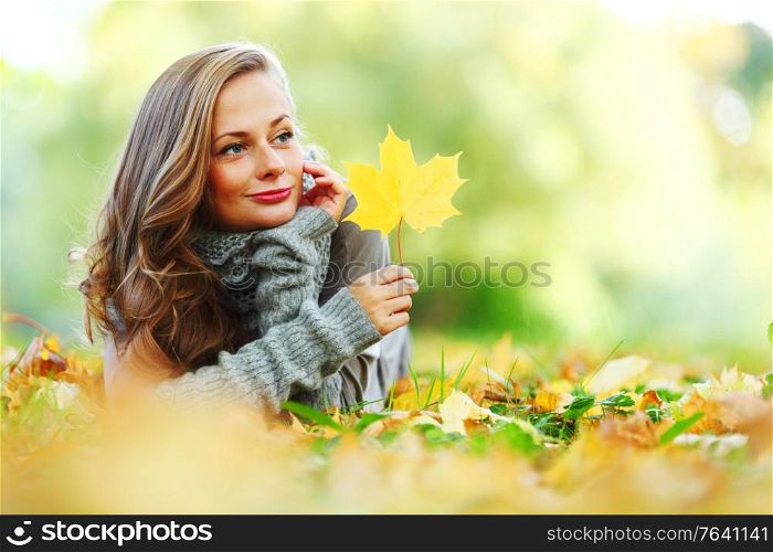 woman portrait in autumn leaf close up. woman portrait with autumn leaf