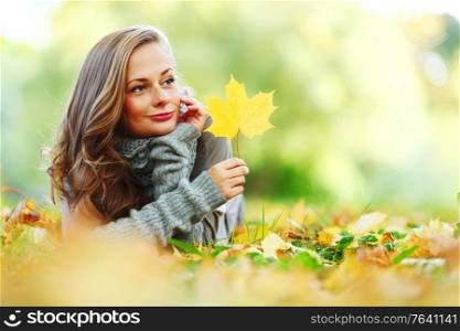 woman portrait in autumn leaf close up. woman portrait with autumn leaf