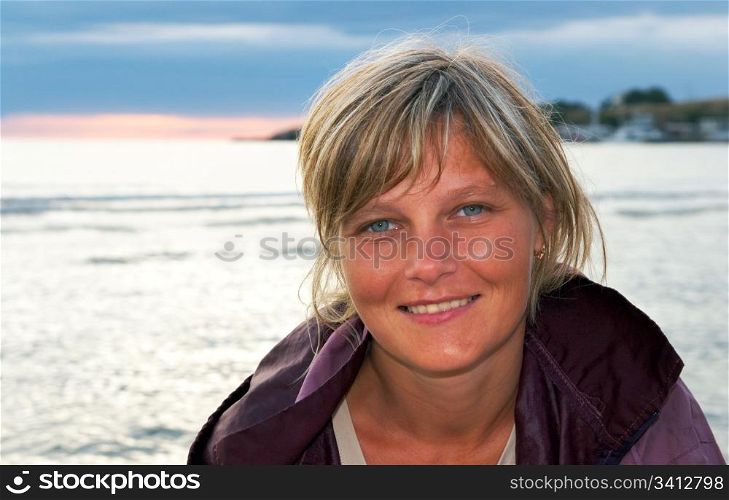Woman portrait on evening sandy sea coast