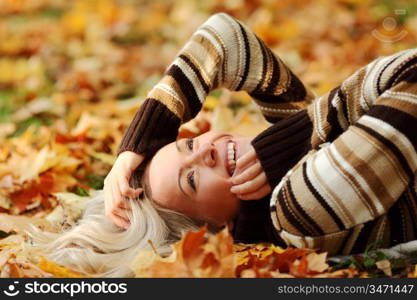 woman portret in autumn leaf close up