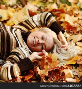 woman portret in autumn leaf close up