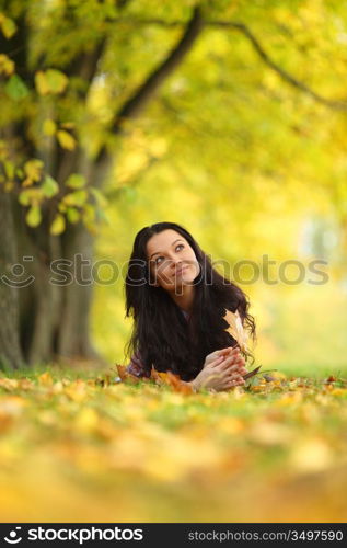 woman portret in autumn leaf close up