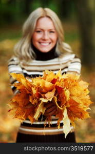 woman portret in autumn leaf close up