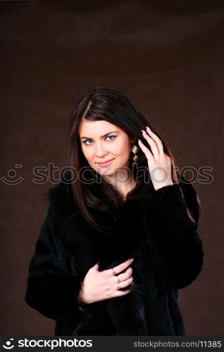 Woman posing against brown background