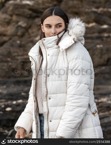 woman posing beach with winter jacket