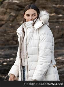 woman posing beach with winter jacket