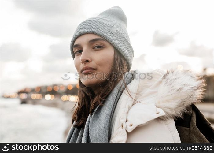 woman posing by beach while road trip