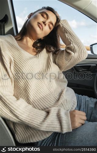 woman posing her car while road trip