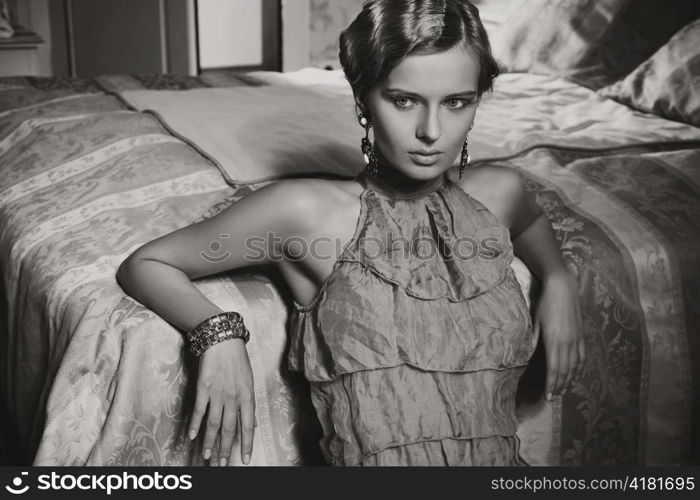 Woman posing in a bedroom.
