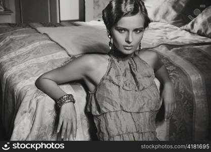 Woman posing in a bedroom.