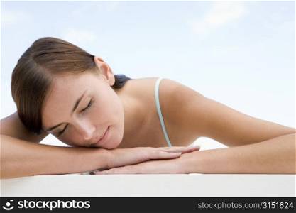 Woman posing outdoors with eyes closed