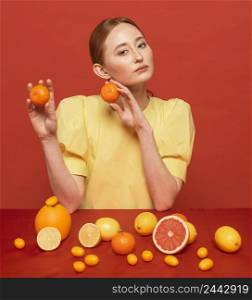 woman posing with arrangement citruses