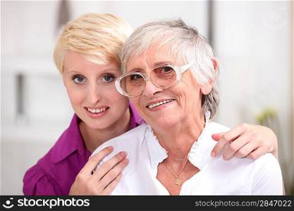 Woman posing with her elderly mother