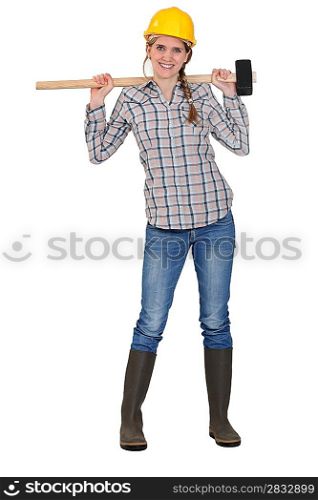 Woman posing with sledge-hammer over shoulders