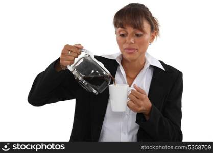 Woman pour coffee into mug