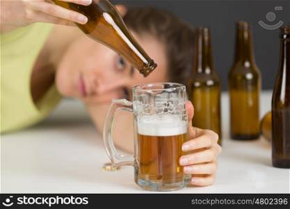 woman pouring a beer out of a bottle