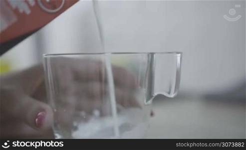 woman pouring glass of milk