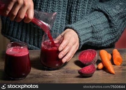 Woman Pouring Self Made Beet Juice In Glass