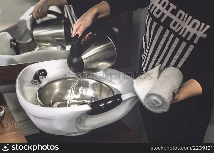 woman pouring water barbershop