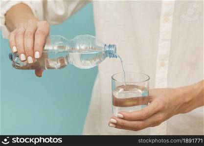 woman pouring water into glass. Resolution and high quality beautiful photo. woman pouring water into glass. High quality and resolution beautiful photo concept