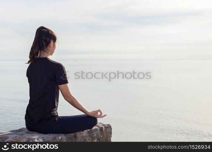 Woman practice yoga lotus pose on the beach,Feeling relax and comfortable,Healthy Concept