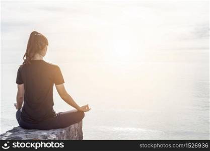 Woman practice yoga lotus pose on the beach,Feeling relax and comfortable,Healthy Concept