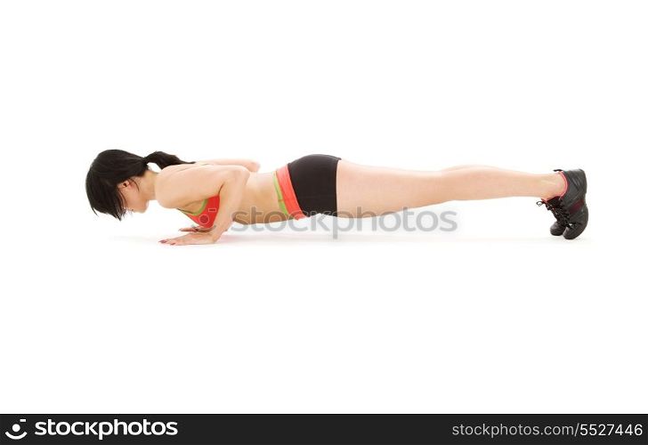 woman practicing chaturanga dandasana four-limbed staff pose