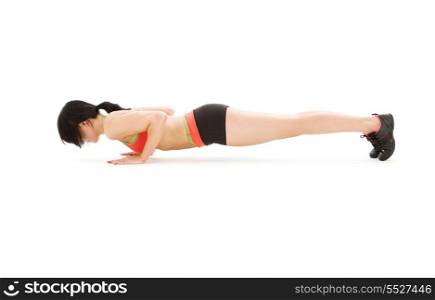 woman practicing chaturanga dandasana four-limbed staff pose