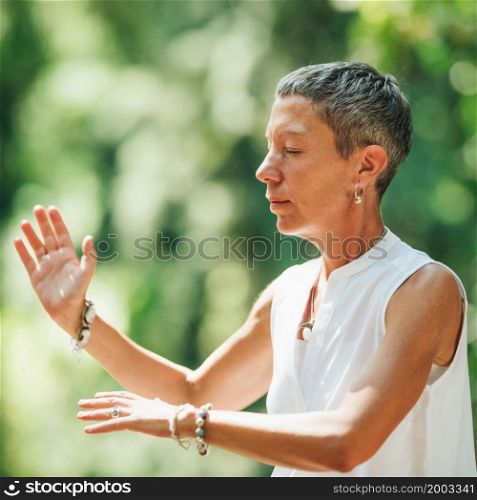 Woman Practicing Qi Gong in a Forest. Woman Practicing Qi Gong in a Forest