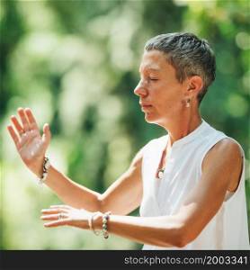 Woman Practicing Qi Gong in a Forest. Woman Practicing Qi Gong in a Forest