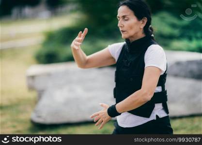 Woman practicing Qi Gong in the park. Chi Gong